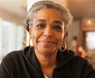 indoor rattan loveseat with cushions and decorative pillows in a bright living room - indoor rattan loveseat