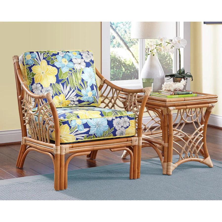Natural Bali end table with a lamp, vase and books beside the Natural arm chair in a blue and yellow floral