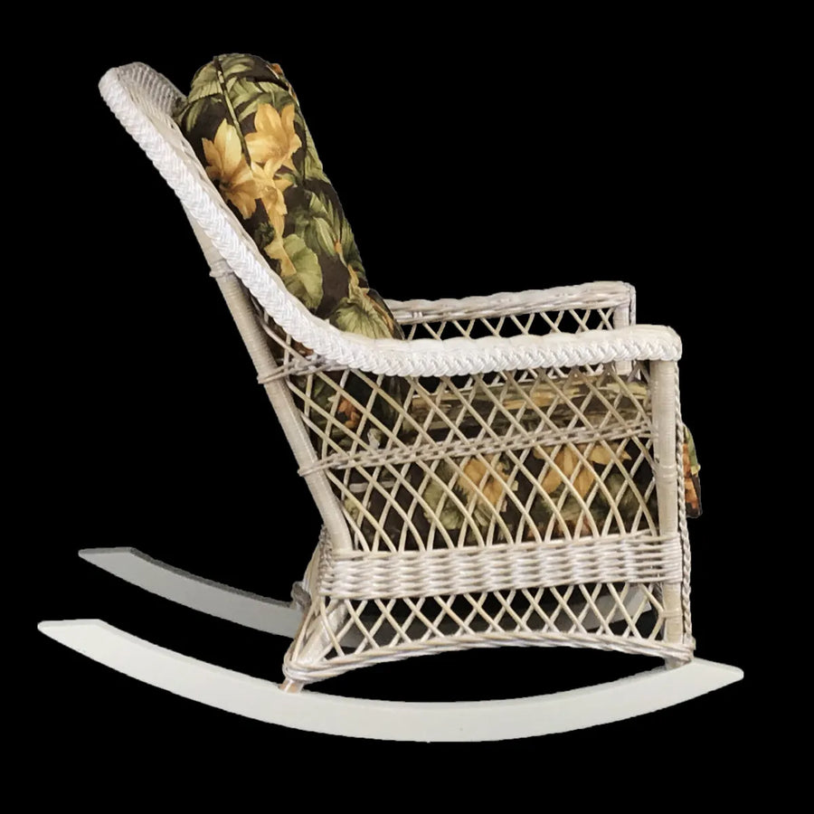 Side view of the Bar Harbor rocker in whitewash showing the long curved runners, lattice side panel and dark floral cushions
