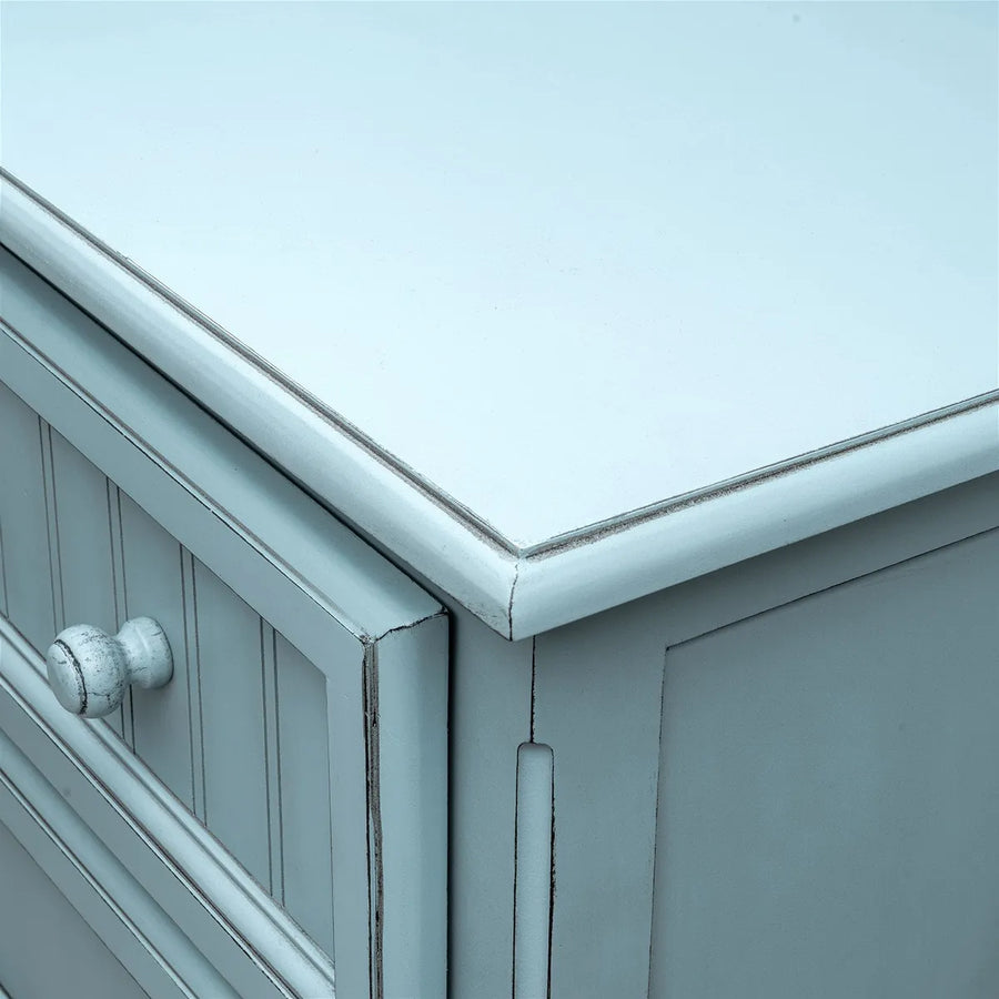 Top corner of the Monaco 5 drawer chest in Bleu with a glazed rounded edge and a beadboard drawer front