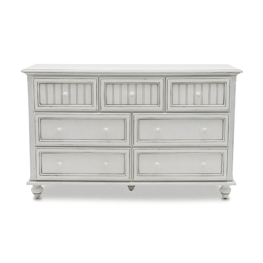 Front view of the Monaco distressed white dresser in Blanc with beadboard top drawers and turned feet