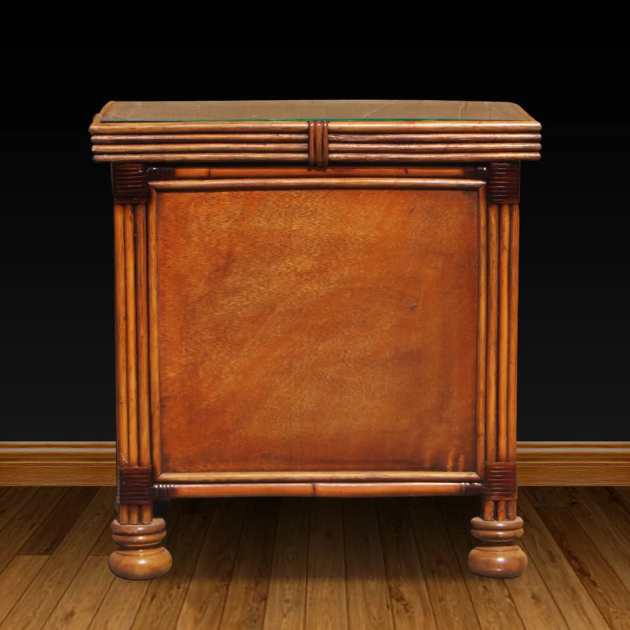 Back of the Royal Palm night stand in Antique Brownwash, a smooth panel framed by fluted posts and bun feet