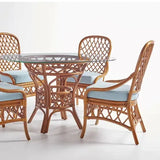 South Sea Rattan Antigua 48-inch round rattan dining set with glass top, lattice-weave pedestal base and four side chairs with light blue cushions