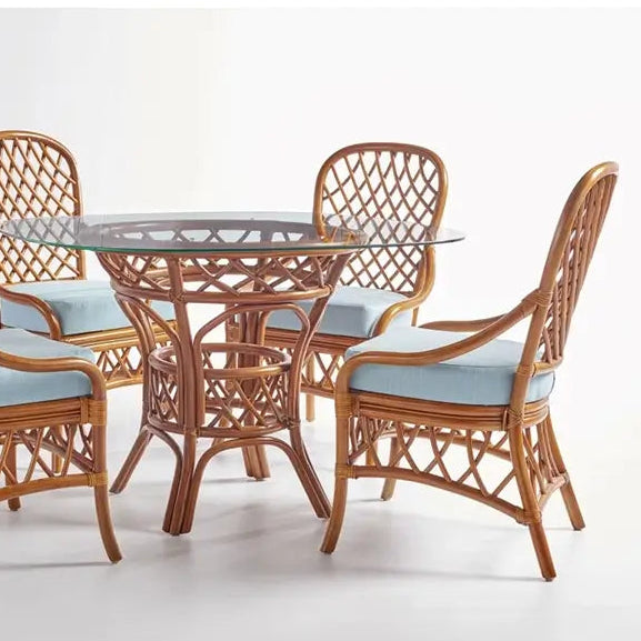 South Sea Rattan Antigua 48-inch round rattan dining set with glass top, lattice-weave pedestal base and four side chairs with light blue cushions