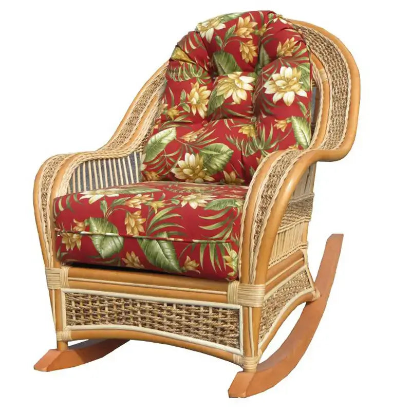 Rattan rocker in a natural finish with red tropical floral cushions printed with cream blossoms and green leaves