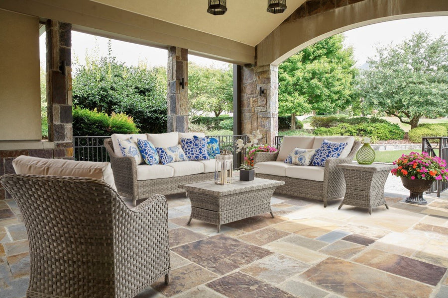 Mayfair chair seen from behind on a covered porch facing a sofa and loveseat