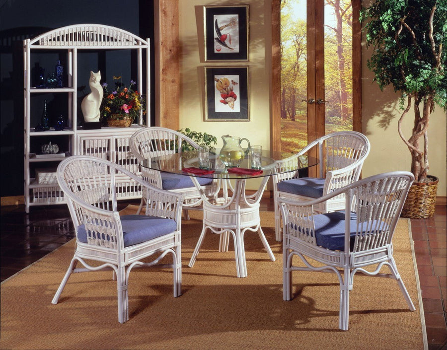 Bermuda dining set in Whitewash with four captain chairs, blue seat cushions and a round glass top on a rattan pedestal