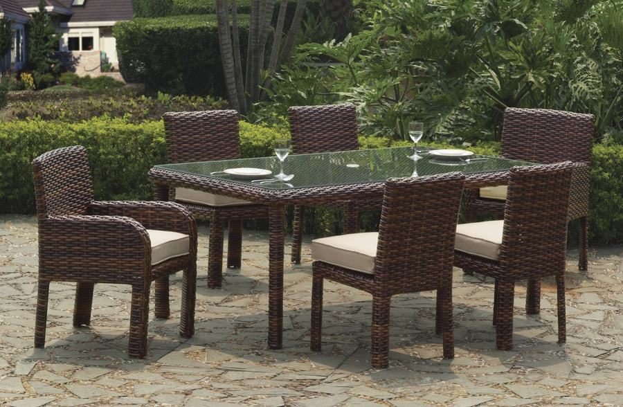 Tobacco St. Tropez dining set with sand cushions and place settings on a stone patio