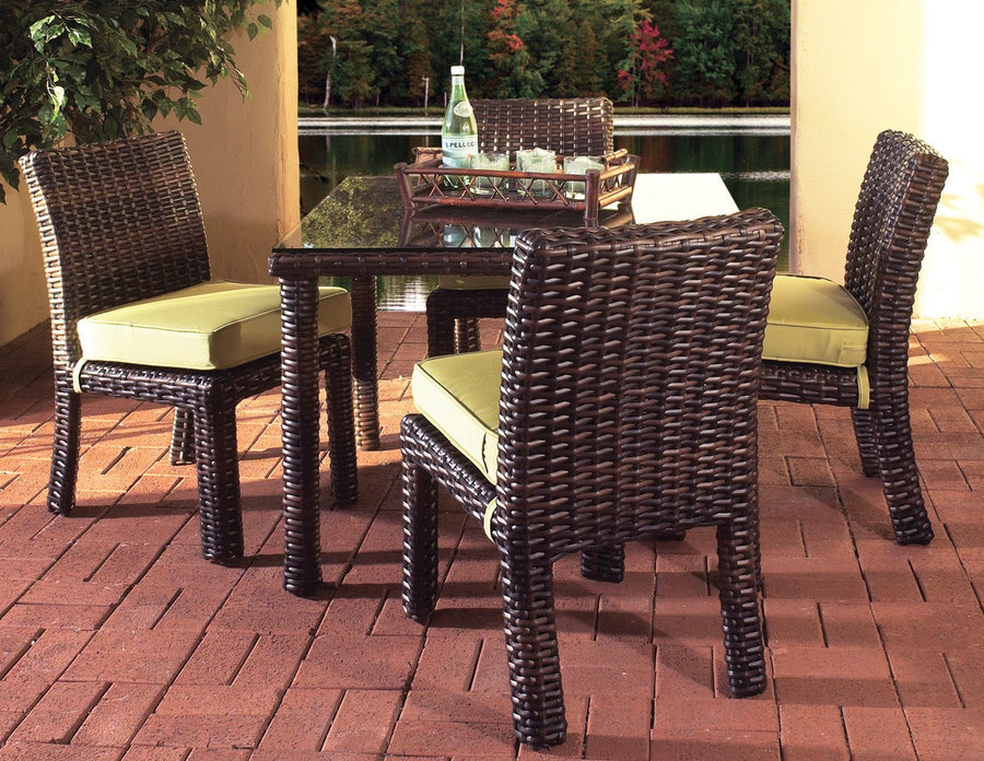 Tobacco St. Tropez square table with four side chairs and lime green cushions on a brick patio