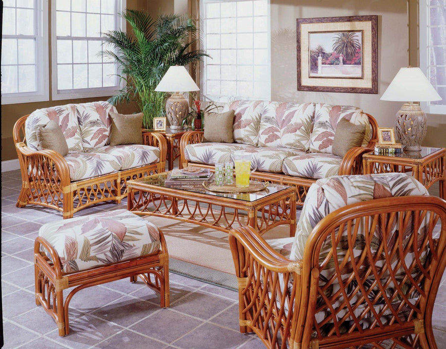 Sunroom furnished with the Antigua sofa, loveseat, armchair, ottoman and two end tables in Walnut rattan