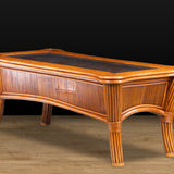Kingston Reef brown wicker coffee table in cinnamon, angled view of the glass top, reed paneled apron and flared legs