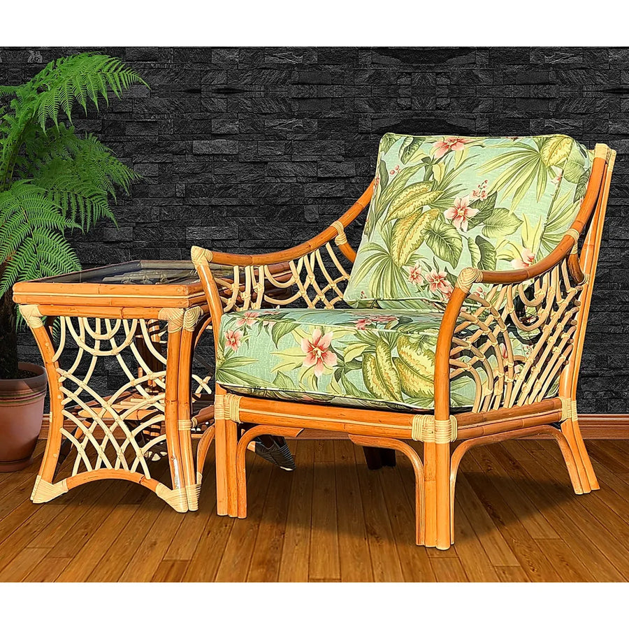 Bali arm chair in Natural with a green leaf and pink blossom print, beside the Natural end table