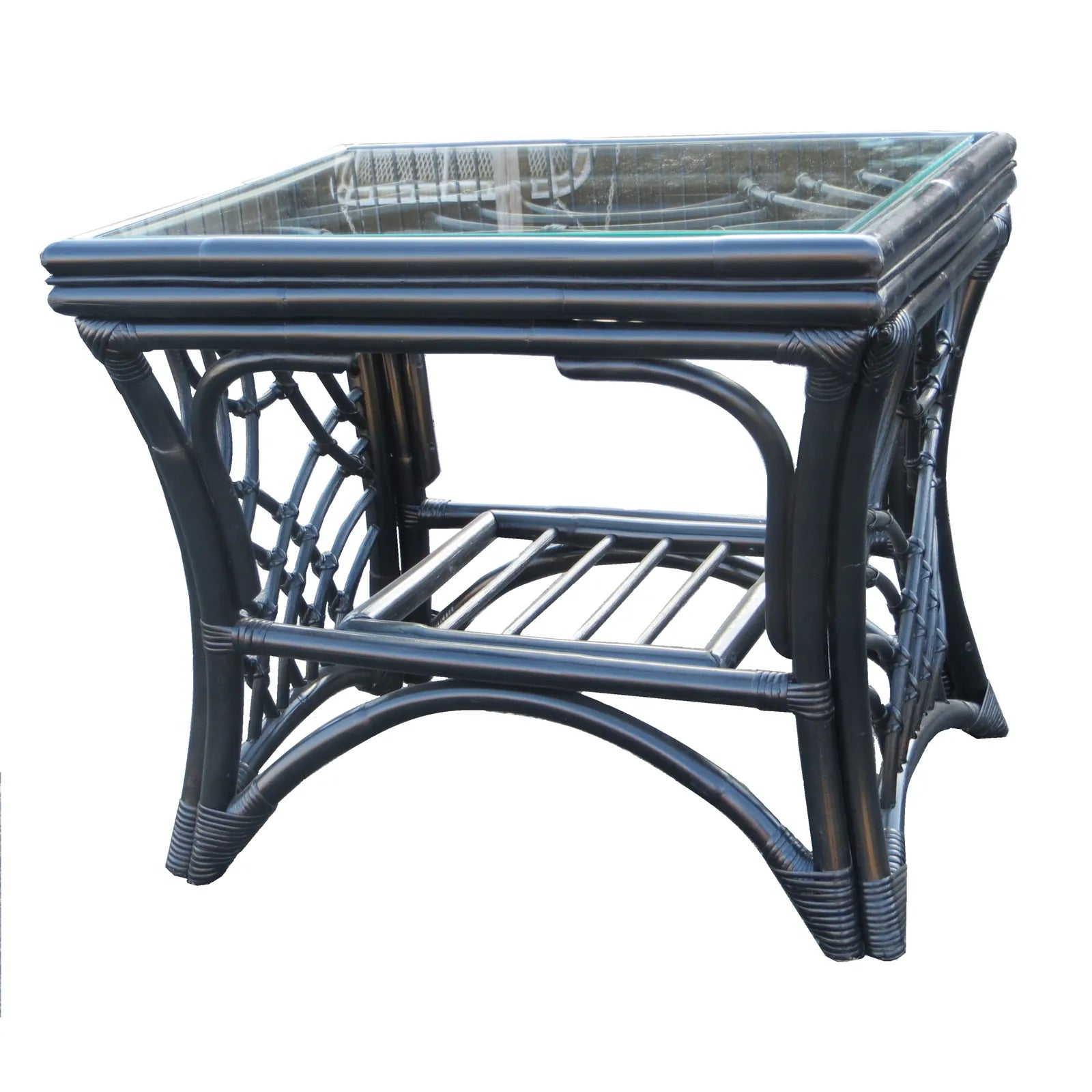 Bali black rattan end table with a glass top, curved rattan fretwork and a slatted lower shelf