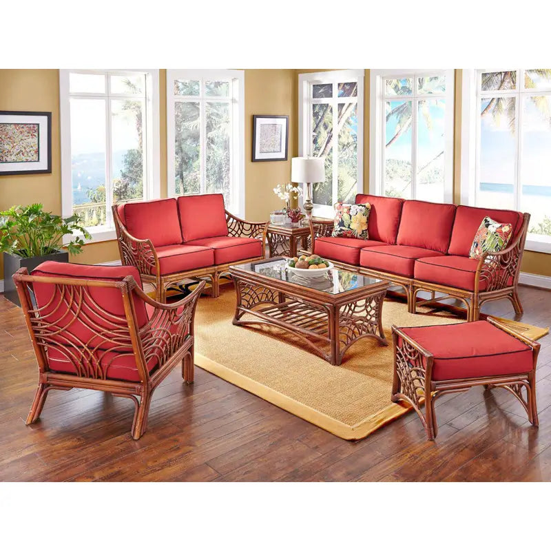 Bali loveseat in Brownwash with red seat and back cushions in a sunroom, beside the matching sofa, chair and ottoman
