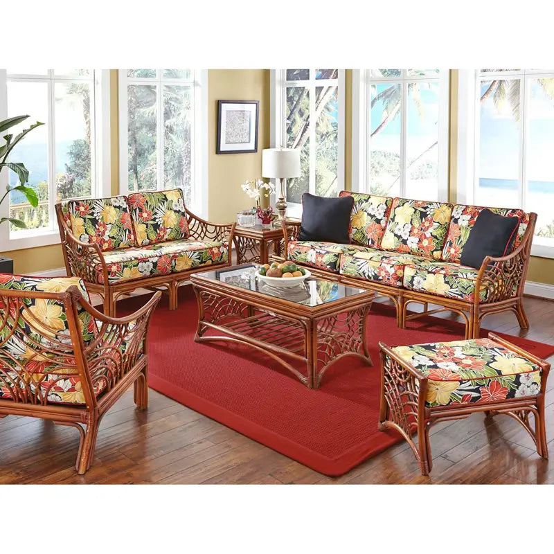 Bali loveseat in Brownwash with black tropical floral cushions in a sunroom set with the sofa and glass top coffee table