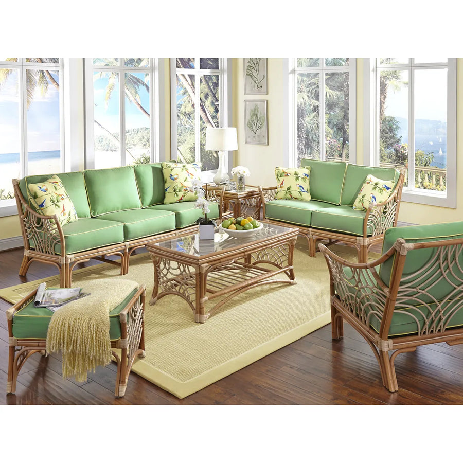 Natural Bali seating with green cushions around the glass topped coffee table on a woven rug in a sunroom