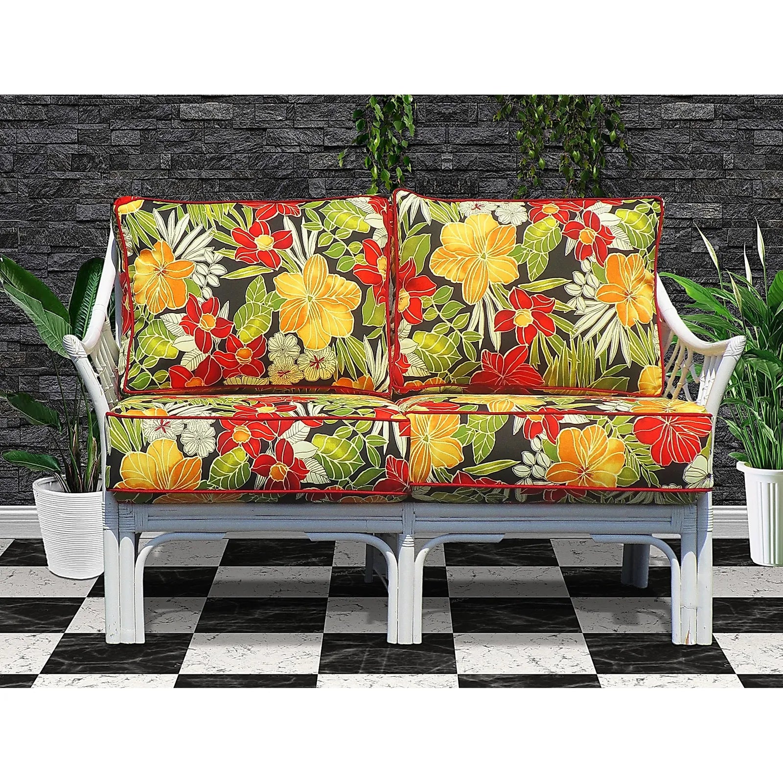 Bali white wicker sofa with red, yellow and green tropical floral cushions, angled view
