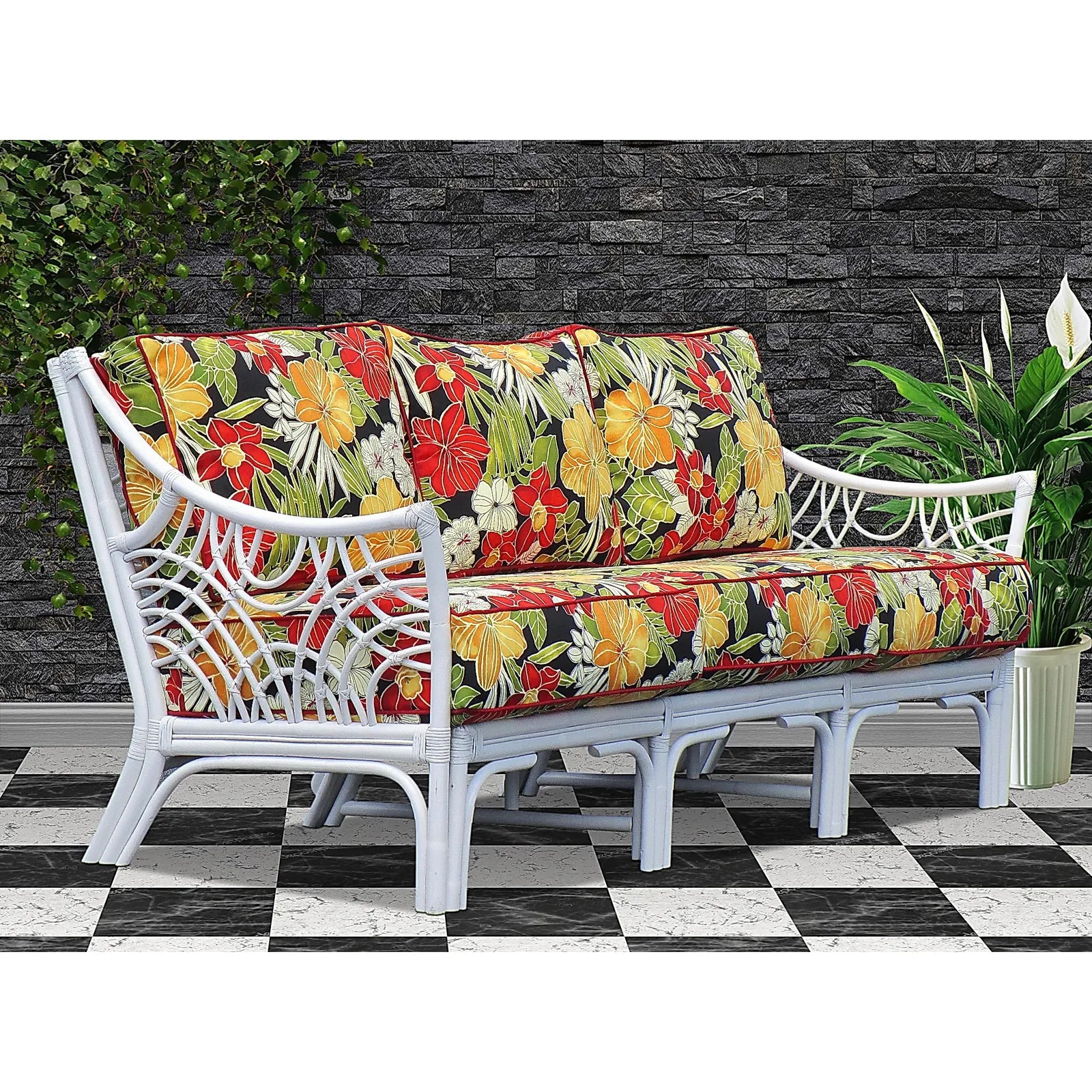 Bali white wicker sofa with red, yellow and green tropical floral cushions, angled view
