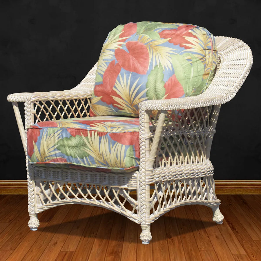 Bar Harbor arm chair in whitewash, angled to show the lattice sides and braided arm edge, with tropical leaf cushions