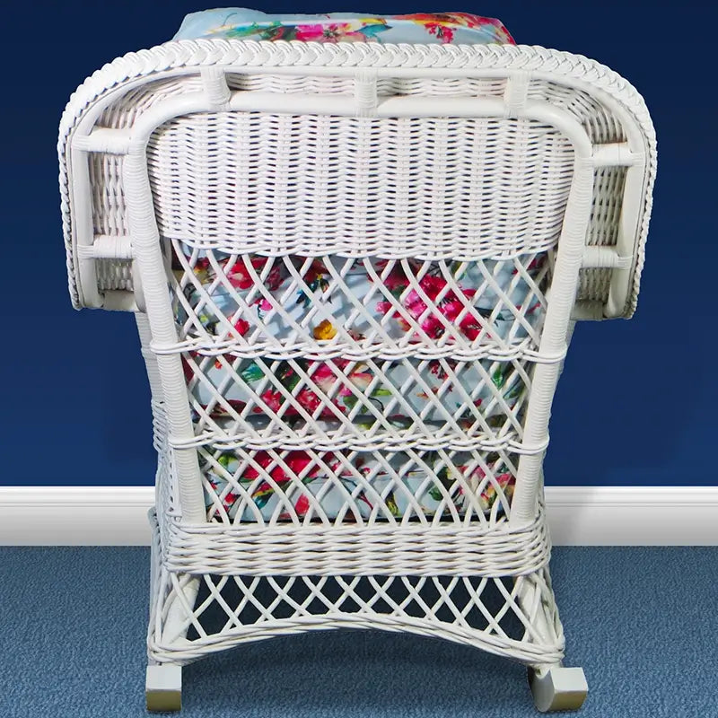 Back of a white woven rocker with a tight-weave top panel above three rows of open lattice and a braided top edge