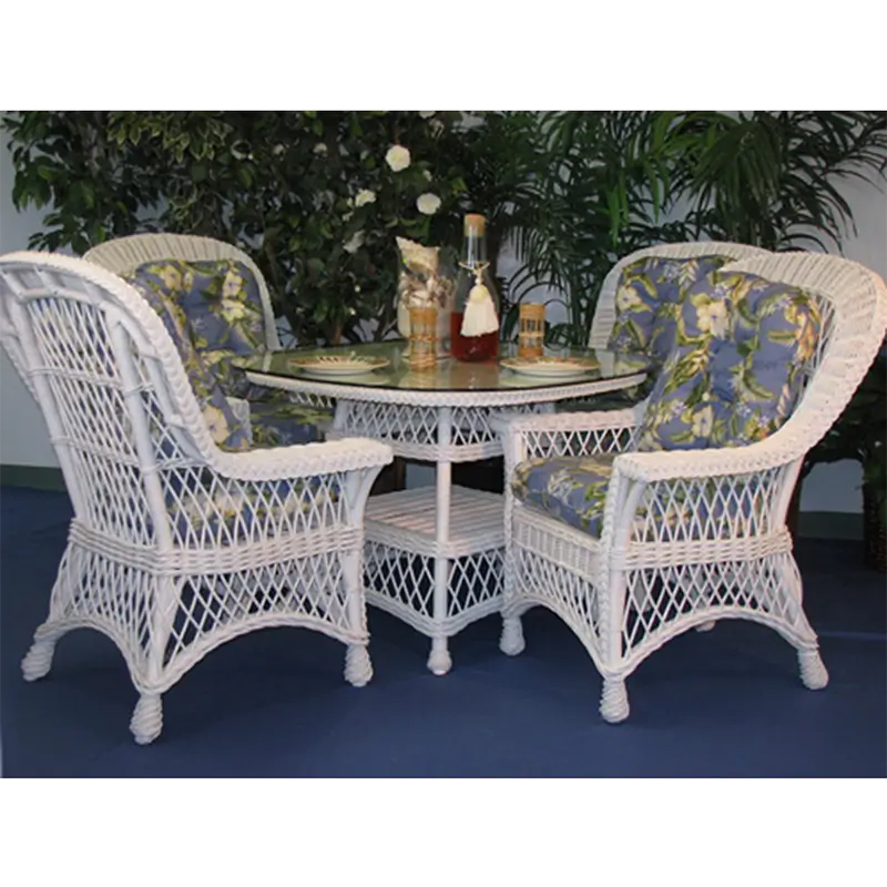 Round wicker dining table in white with a glass top, diamond lattice band and woven lower shelf, front view