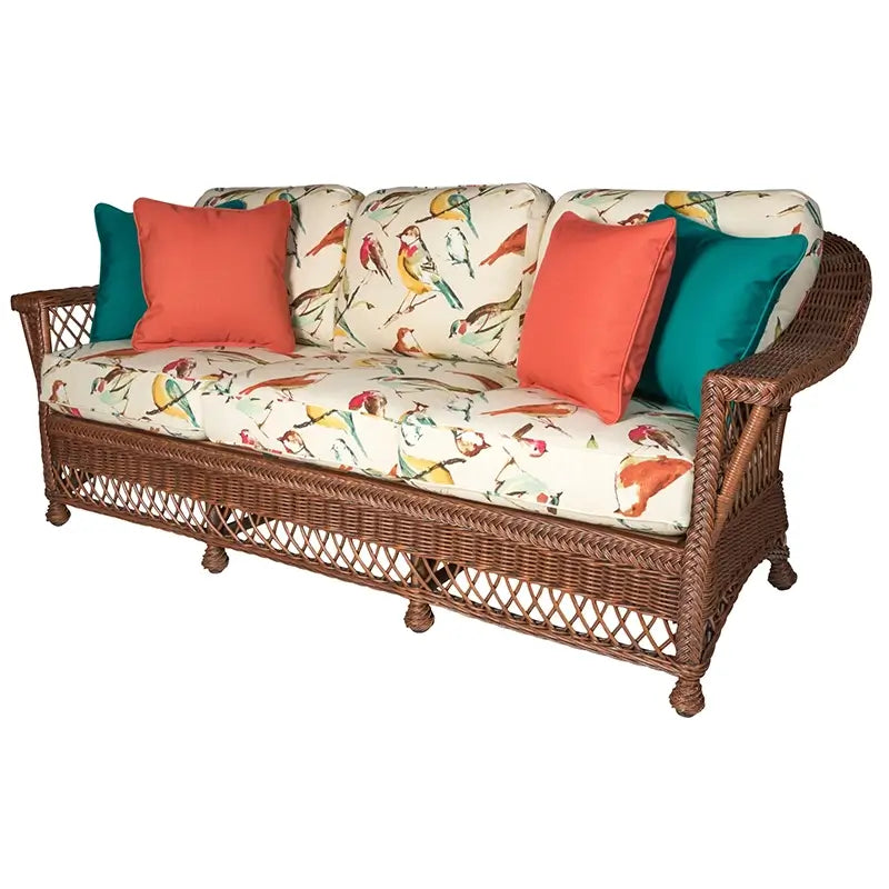 Bar Harbor Sofa in Coffee finish with bird-print cushions and coral, teal accent pillows
