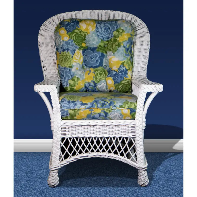 Front view of a white wicker Bar Harbor dining chair with arms and blue, green and yellow floral cushions
