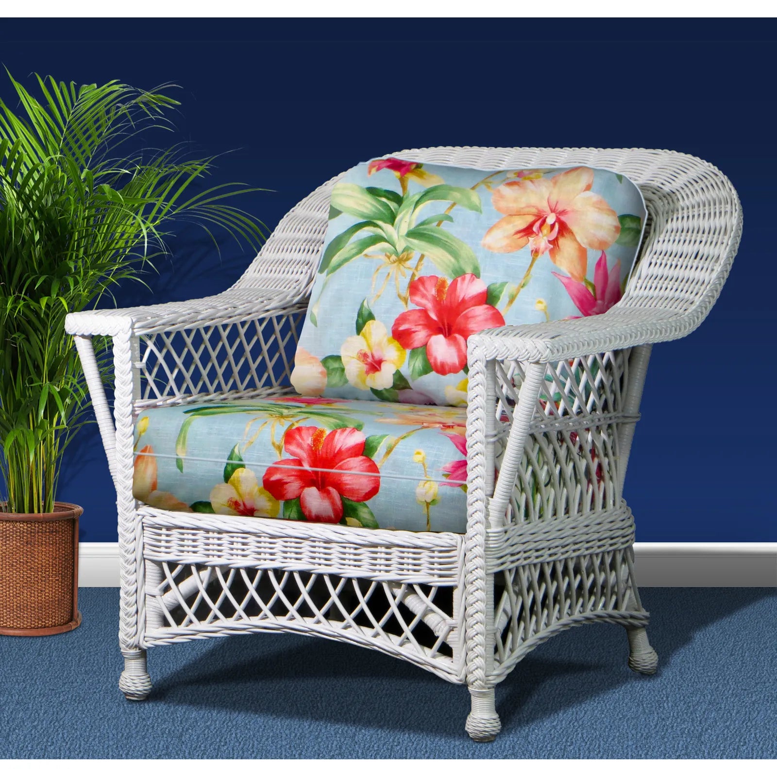 Bar Harbor white wicker armchair with light blue hibiscus print cushions, angled view