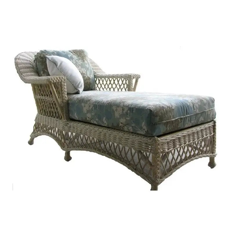Bar Harbor vintage wicker chaise lounge in Whitewash with a blue floral seat cushion, matching back pillow and white pillow