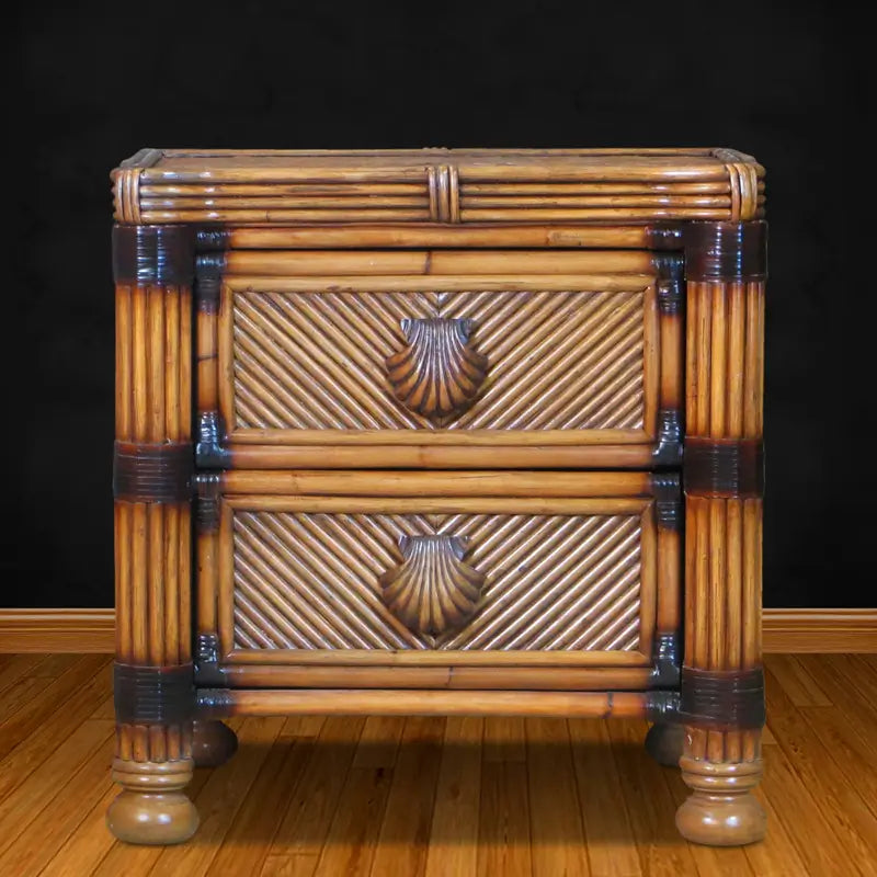 White wicker nightstand, front view, with two diagonal-woven drawers, seashell pulls and round bun feet