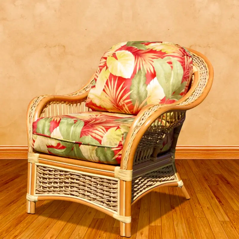Islander indoor wicker arm chair in natural finish, angled view, with red and green tropical leaf fabric