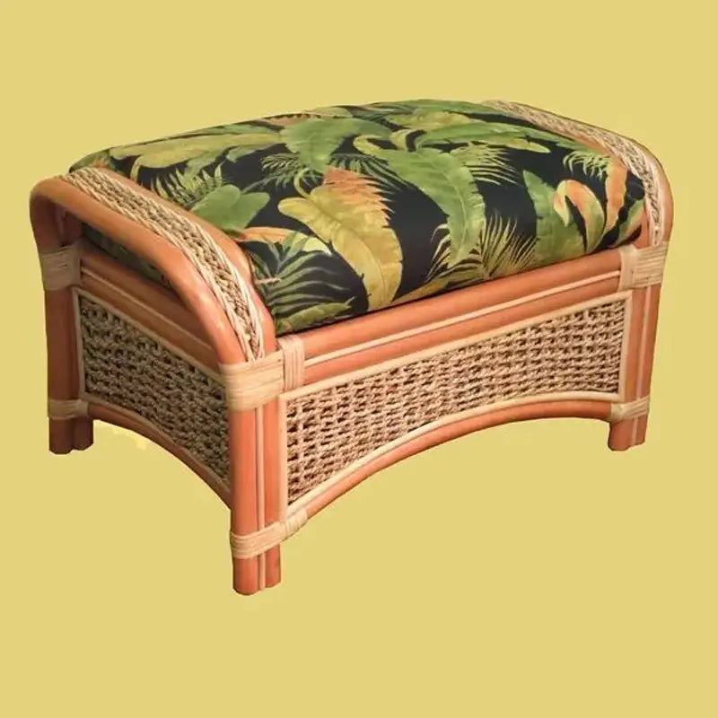 Islander ottoman in Natural with a dark tropical leaf cushion