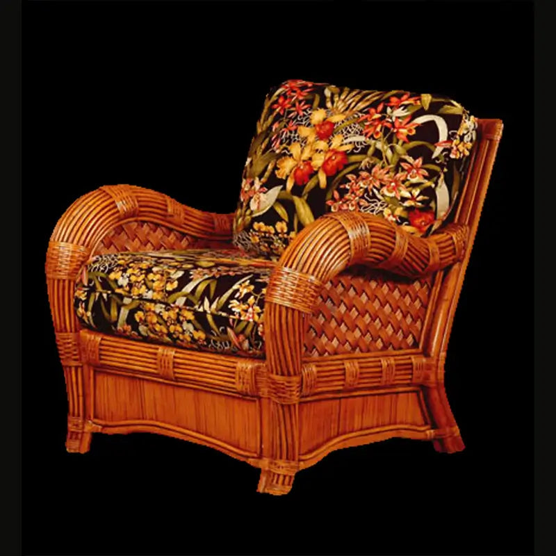 Kingston Reef arm chair in cinnamon with black orchid print cushions, in front of a warm tan wall on a wood floor