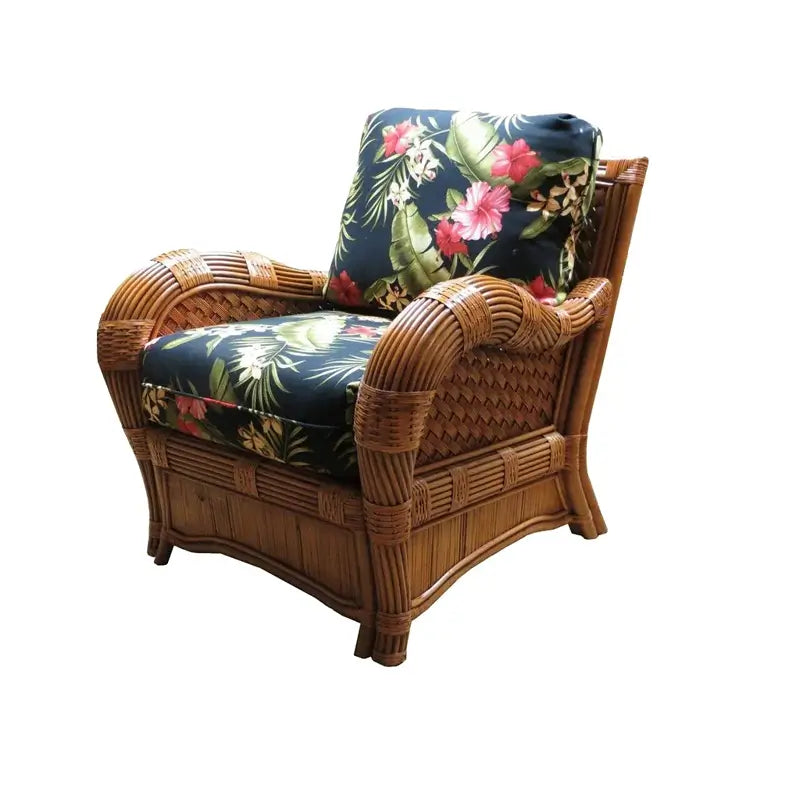 Kingston Reef rattan chair with cushion in cinnamon, angled view, with black hibiscus and palm leaf print cushions