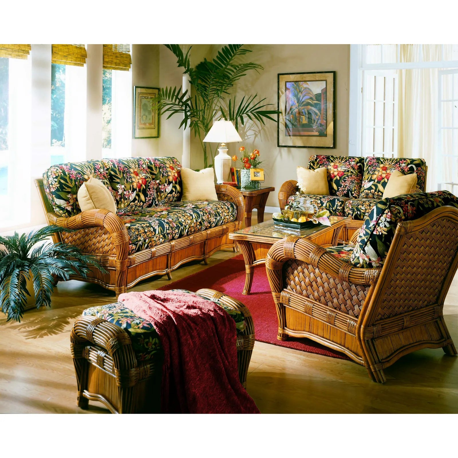 Cinnamon wicker couches: the Kingston Reef sofa with black tropical floral cushions and cream throw pillows