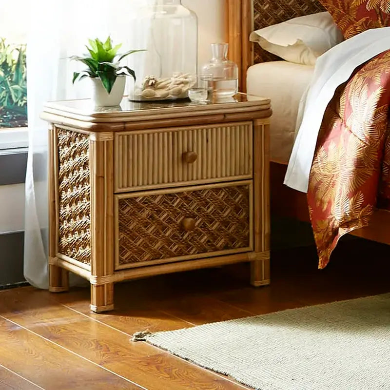 Nightstand from the Mandalay king bedroom set with a reeded top drawer and a woven bottom drawer, set beside the bed