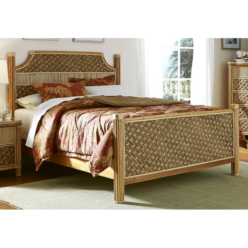 Rattan king bed in a natural finish with woven panels at the head and foot, dressed in red tropical-print bedding
