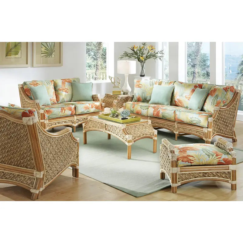 Mauna Loa sofa, loveseat, arm chair, ottoman and coffee table in a natural finish, arranged on a pale green rug