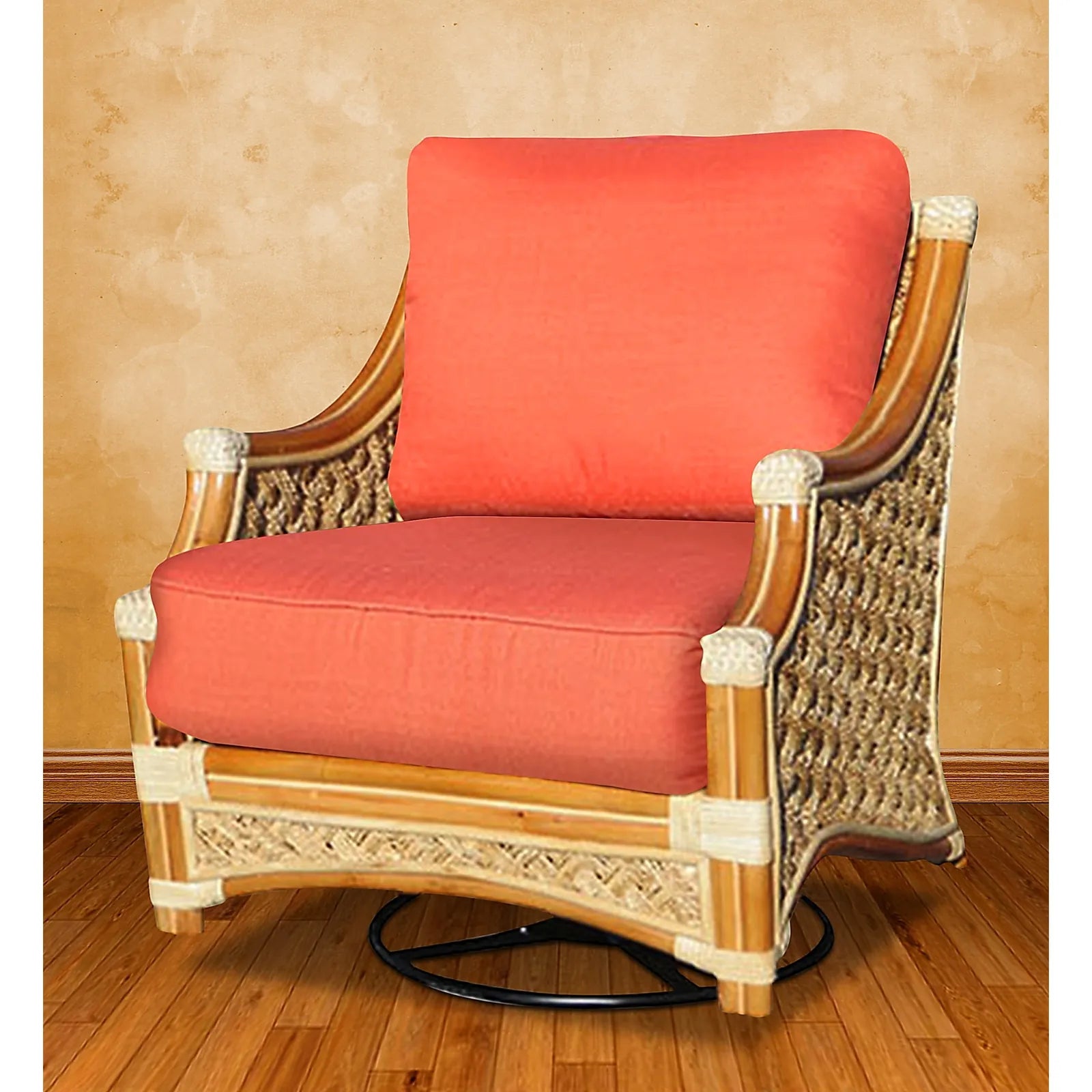 Mauna Loa rattan swivel rocker in Natural with red tropical floral cushions, angled to show the swivel base