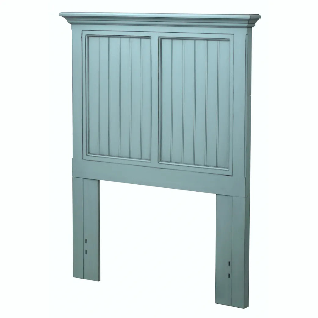 Monaco headboard in Bleu, twin size, seen from an angle to show its two panels, crown molding and long legs