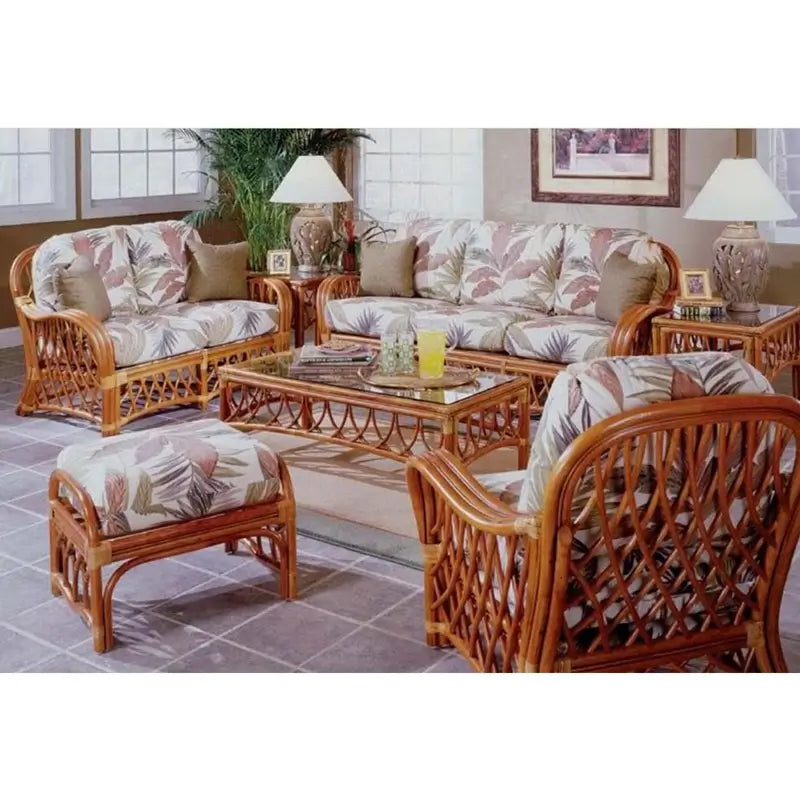 Montego Bay rattan living room set in a sunroom, with rose print cushions, green pillows, coffee table and end table