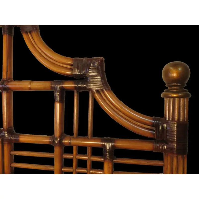 Detail of a curved shoulder rail with dark wrapped joints, a fluted post and a round ball finial