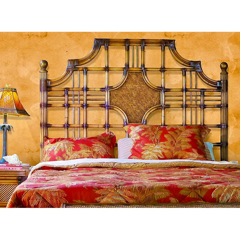 Royal Palm queen headboard in Antique Brownwash against a warm amber wall, its open lattice framing the medallion
