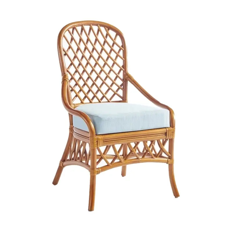 South Sea Rattan Antigua 48-inch round glass-top dining table with four lattice-weave rattan side chairs and light blue cushions