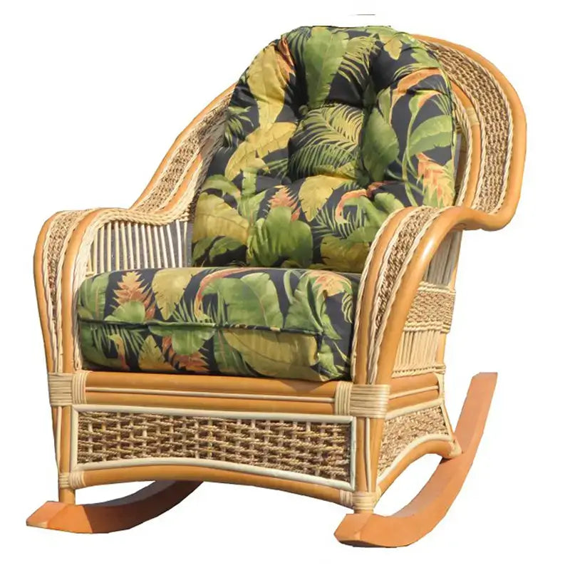 Rocker with a honey-toned rattan frame and dark cushions printed with green and gold palm and banana leaves