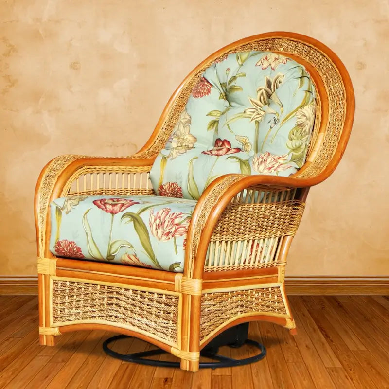 Spice Island swivel rocker in natural rattan with aqua floral cushions and a black swivel base on white