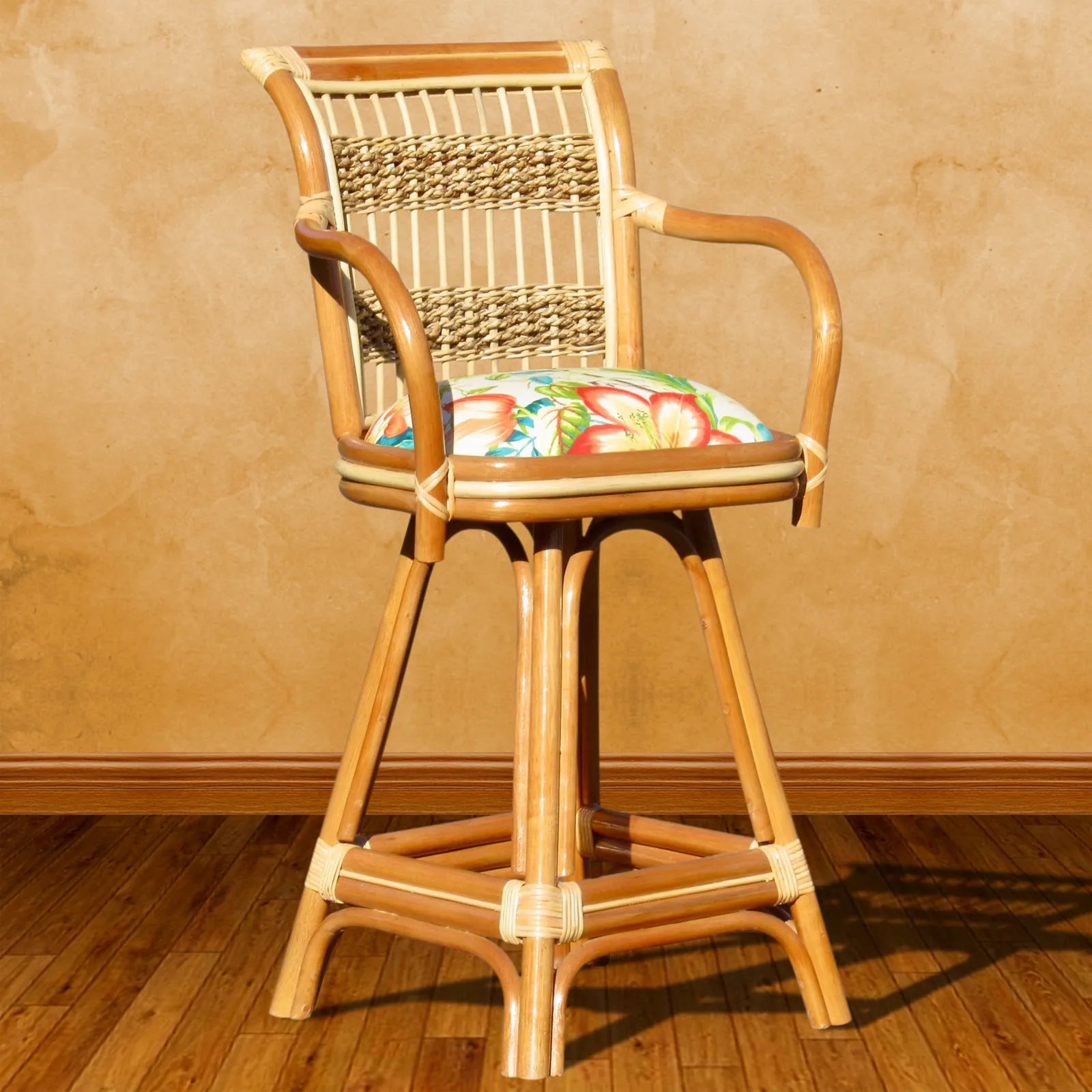 Wicker counter stool from the Spice Island collection in Natural, with arms, a woven back and a tropical print seat cushion