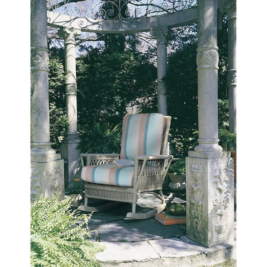 Sage Windsor Rocker with striped cushions among the stone columns of a garden pavilion