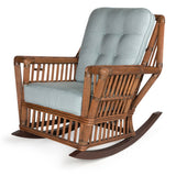 Brown wicker rocking chair from the Williamsburg Collection with aqua tufted cushions and dark wood rockers