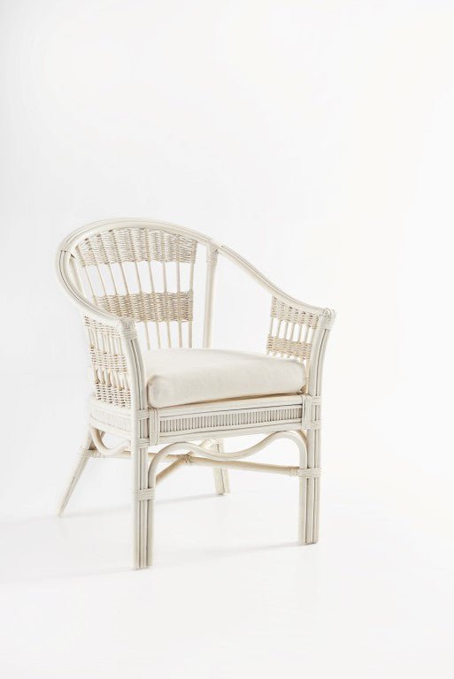 Bermuda Captain Chair in Whitewash rattan with a rounded woven back and cream seat cushion